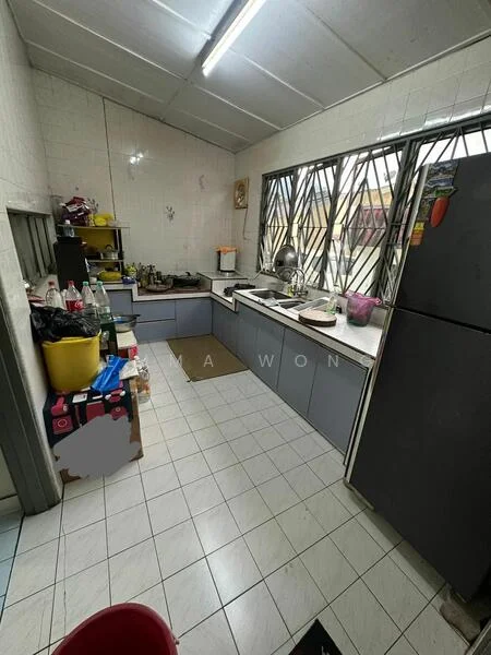Kitchen features: grey cabinetry, white tiled walls, white tiled flooring, single-bowl stainless-steel sink, chrome pull-down faucet, built-in oven, freestanding fridge, countertop with clutter, window with security bars, overhead fluorescent lighting, kitchen utensils on countertop, plastic storage bins, bottled drinks on countertop.