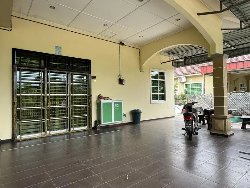 Exterior type: linked terrace house; features: yellow painted facade, tiled flooring, covered porch area, metal security grille door, green storage cabinet, outdoor seating area, motorcycle parked, windows with green frames, exposed ceiling with lights; style: modern.