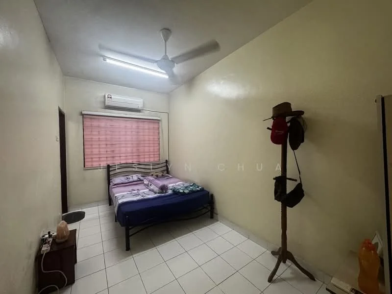Bedroom features: white painted walls, ceiling fan, window with blinds, tiled flooring, queen-size bed, bedside table, air conditioning unit, clothes rack, hats on rack, decorative lamp.