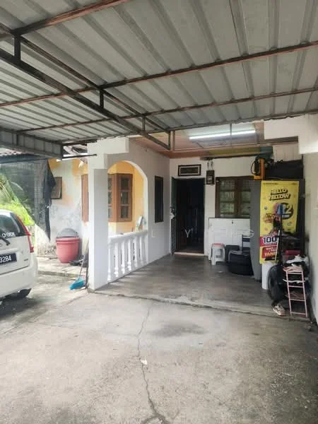 Exterior type: linked terrace house; features: covered car porch, concrete flooring, white painted facade, yellow accent wall, window with wooden frame, security grill on door, exposed metal roof, outdoor storage area, visible parking space; style: traditional.