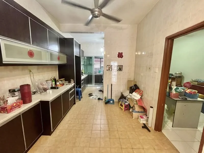 Kitchen features: dark wood cabinetry, white countertop, ceramic tile flooring, 5-blade ceiling fan, built-in glass display cabinet, stainless-steel sink, wall-mounted shelving, cluttered countertop with various items, tile backsplash, multiple visible appliances including a kettle and rice cooker.