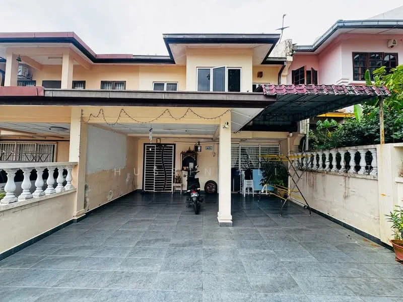 Exterior type: semi-detached house; features: covered car porch, grey tiled flooring, white painted facade, red tiled roof, exterior wall with light fixtures, manicured plants along the boundary, metal gate, windows with grills, balcony on upper floor; style: modern.