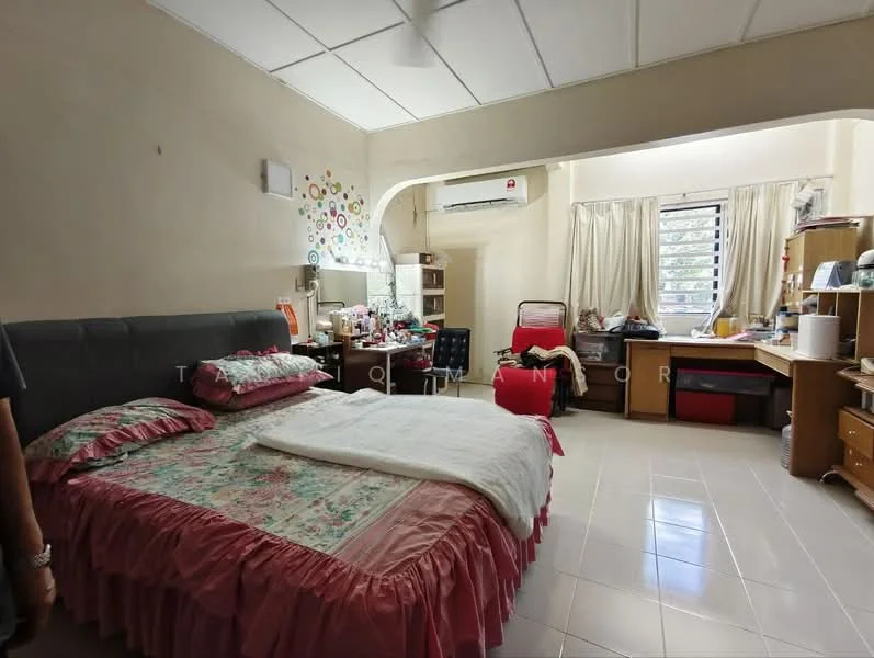 Bedroom features: queen-size bed with floral bedding, upholstered headboard, 2 bedside tables, desk with chair, built-in wardrobe, window with sheer curtains, wall-mounted air conditioning unit, light-colored tiled flooring, decorative wall with colorful circles, study lamp, personal items on desk.