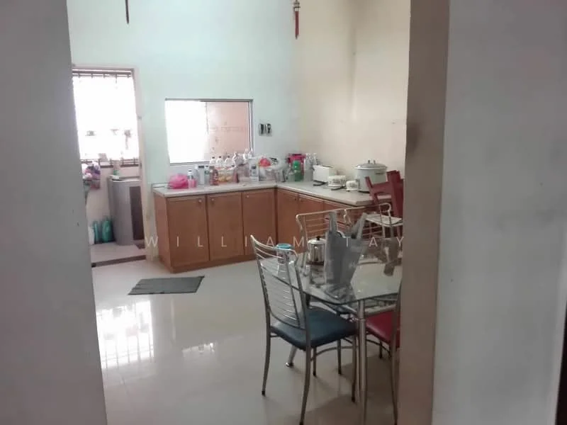 Kitchen features: wood cabinetry, white walls, ceramic tile flooring, dining table with metal legs and colored chairs, sink, countertop, window with natural light, various kitchen appliances and utensils on countertop.
