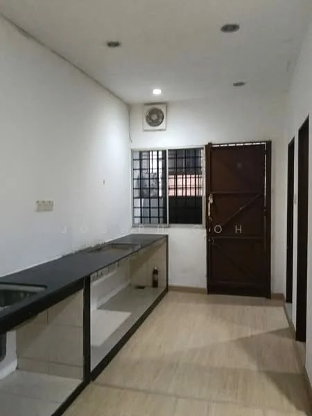 Kitchen features: black countertop, stainless-steel sink, wall-mounted air conditioning unit, white painted walls, tile flooring, wooden door, grilled window, built-in cabinetry.