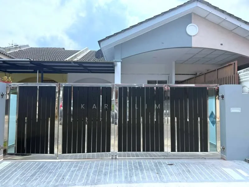 Exterior type: linked terrace house; features: modern metal gate with vertical slats, concrete driveway, light grey painted facade, sloped roof, overhang at entrance, glass panel beside gate, paved walkway, surrounded by residential area; style: modern.