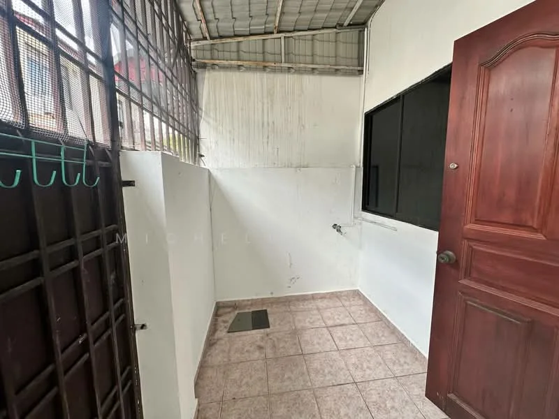 Room features: white painted walls, grey tiled flooring, metal ceiling, single door with wood finish, window with metal grille, drainage outlet on floor.
