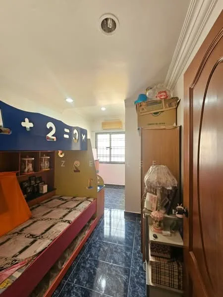 Bedroom features: blue accent wall with mathematical symbols, single bed with patterned bedding, built-in shelving unit, wooden door, window with sheer curtains, ceiling lights, dark blue tiled flooring, air conditioning unit; style: modern.