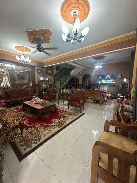 Living features: white painted walls, cream ceiling with decorative moulding, 5-blade ceiling fan with light, chandelier, marble tile flooring, large area rug with intricate pattern, wooden coffee table, upholstered armchairs, sofa set with floral upholstery, TV console, wall-mounted TV, decorative wall clock, curtains, decorative plants, staircase leading to upper floor; style: traditional.
