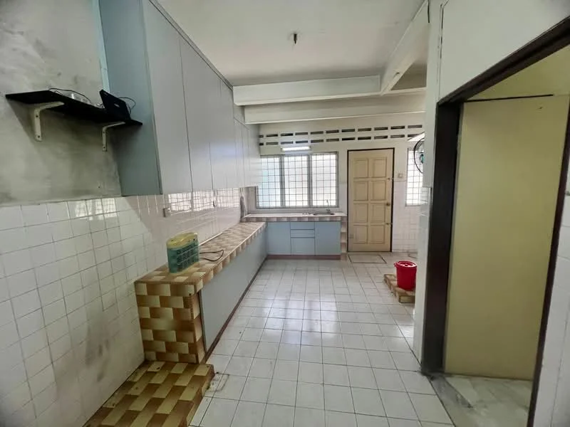 Kitchen features: white tiled walls, grey cabinetry, laminate countertop, single-bowl stainless-steel sink, wall-mounted shelf, window with grid pattern, ceramic tile flooring, built-in cabinets, kitchen layout with L-shape, doorway leading to another room.
