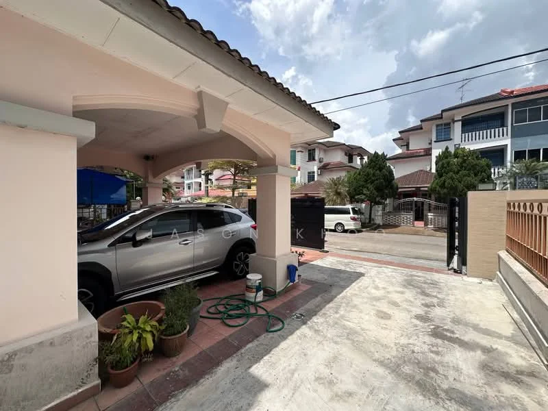 Exterior type: linked terrace house; features: car porch with awning, paved driveway, manicured garden with potted plants, white painted facade, flat roof, surrounded by mature greenery, security gate, adjacent to residential street; style: modern.