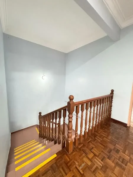 Room features: wooden staircase with balustrade, yellow painted stair treads, light blue painted walls, wooden flooring, ceiling with crown moulding, wall-mounted light fixture; style: traditional.