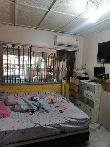 Bedroom features: queen-size bed with patterned bedding, wooden headboard, 2 bedside lamps, wall-mounted TV, 1 wall-mounted split AC, window with security bars, light-colored walls, ceiling with panels, laminate flooring, dresser with multiple drawers, storage cabinet, decorative items on dresser.