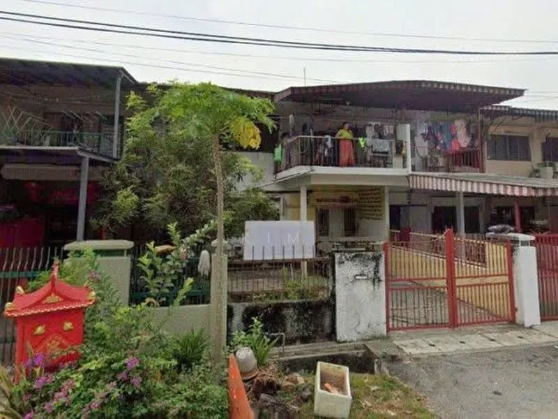 Exterior type: linked terrace house; features: two-storey building, red and white painted facade, balconies on upper floor, metal roof, fenced front yard, manicured garden with plants, clothes hanging on balcony, decorative Chinese lantern, driveway with interlocking pavers, visible entrance gate; style: traditional.