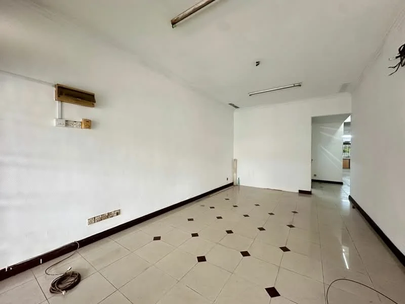 Room features: white painted walls, tile flooring with dark accent tiles, ceiling lights, air conditioning unit, power outlets, empty space, no visible furniture, neutral color scheme.