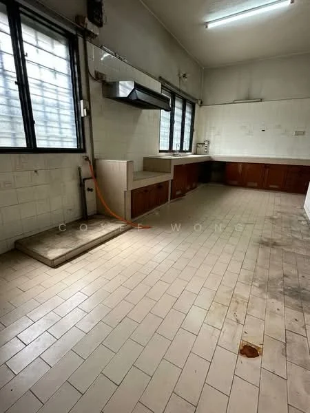 Kitchen features: white tiled walls, cream tiled flooring, wood cabinetry, stainless-steel range hood, single-bowl stainless-steel sink, countertop with no visible backsplash, two large windows, overhead fluorescent lighting, plumbing visible, cleaning area with floor drain.