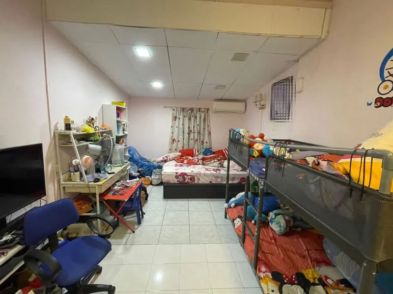 Bedroom features: pink painted walls, white ceiling, tile flooring, bunk bed with colorful bedding, queen-size bed with colorful bedding, wall-mounted air conditioning unit, window with curtains, TV on stand, desk with chair, shelves with toys and books, decorative wall stickers.