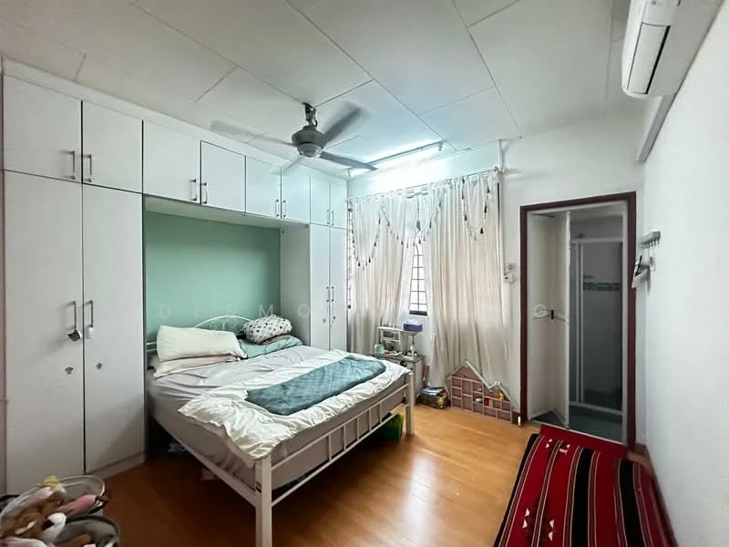 Bedroom features: single bed with bedding, built-in wardrobe with white doors, green accent wall behind bed, wooden flooring, ceiling fan, window with sheer curtains, wall-mounted air conditioning unit, small bedside table, decorative items on shelves, rug on floor; style: modern.