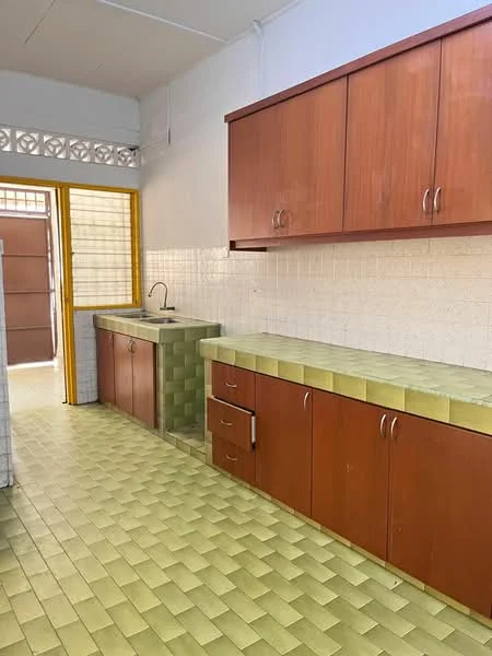 Kitchen features: green tiled countertop, wooden cabinetry in brown, single-bowl sink, chrome faucet, green tiled flooring, white tiled walls, window with yellow frame, open layout to outdoor area.