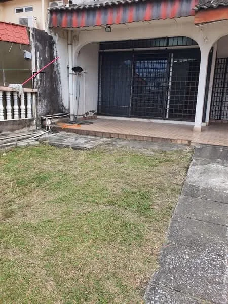 Exterior type: linked terrace house; features: front yard with grass, paved walkway, covered porch area, metal grille doors, exposed brick wall, red tiled roof, concrete flooring, fenced perimeter, outdoor lighting fixture; style: traditional.