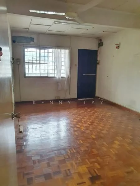 Room features: wooden flooring, white painted walls, window with sheer curtains, ceiling fan, light fixture, door, baseboard, corner wall with electrical outlets.