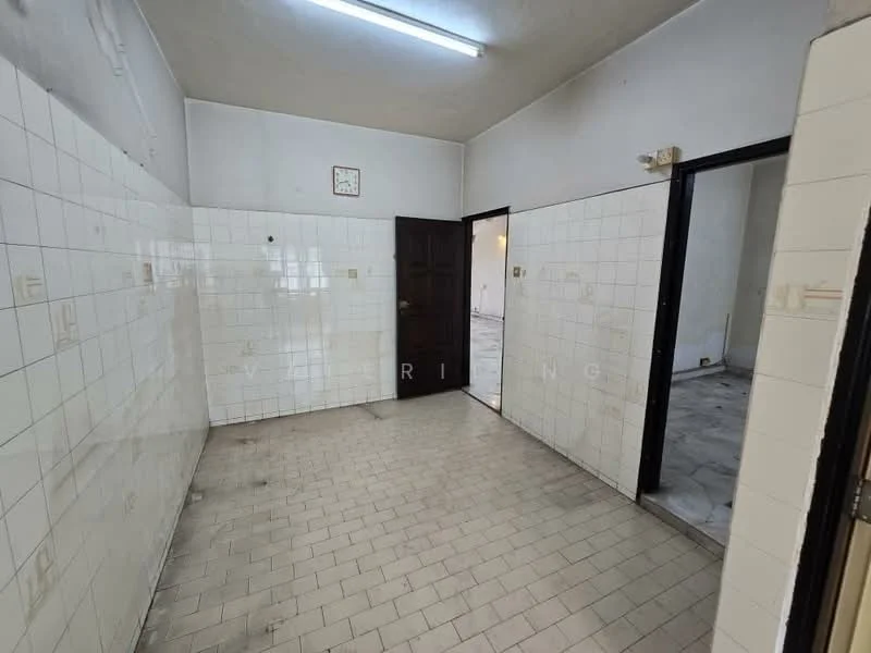 Room features: white tiled walls, grey tiled flooring, single door, clock on wall, two doorways, fluorescent ceiling lights.