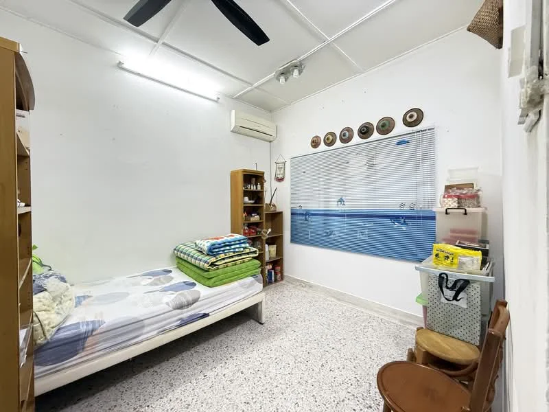 Bedroom features: single bed with mattress, green and white bedding, wooden bookshelf, wall-mounted air conditioning unit, white painted walls, ceiling fan, window with blinds, speckled tile flooring, storage bins, wooden chair; style: minimalist.