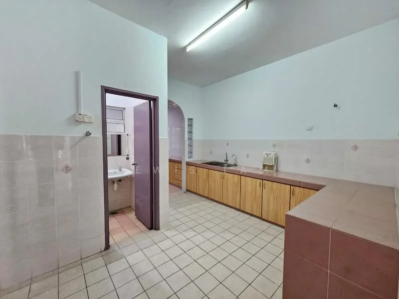 Kitchen features: light blue painted walls, white tiled walls, brown wooden cabinetry, double-bowl sink, chrome faucet, countertop with pink surface, ceramic tile flooring, fluorescent ceiling light, open layout, window above sink. Room features: white tiled walls, ceramic tile flooring.