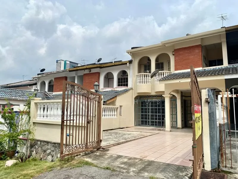 Exterior type: linked terrace house; features: two-storey building, brick facade with cream painted walls, arched windows, balcony with railing, tiled porch area, gated entrance, manicured lawn, paved walkway, satellite dishes on roof, surrounded by greenery; style: modern.