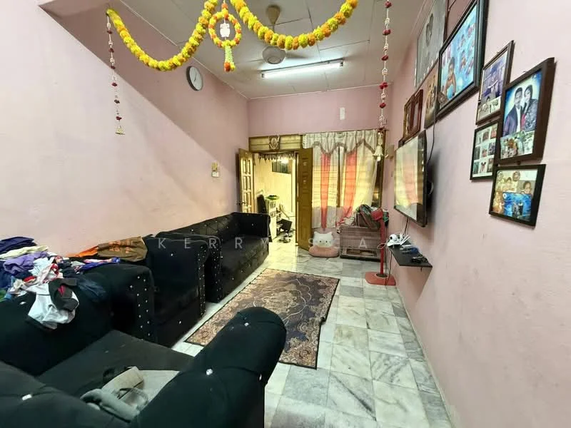 Living features: pink painted walls, marble flooring, 2 black fabric sofas, area rug with traditional pattern, wall-mounted TV, TV console, decorative wall with family photos, ceiling fan, clock on wall, hanging decorative garland, curtains on window, light fixture on ceiling; style: traditional.
