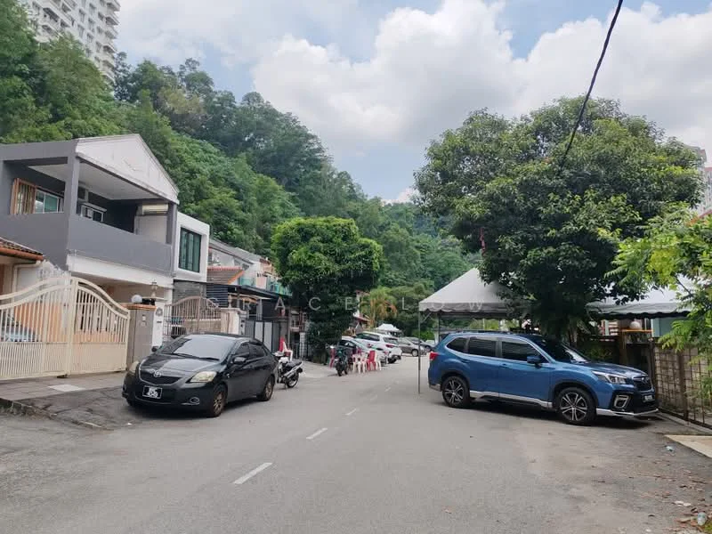 Exterior type: linked terrace house; features: two-storey linked terrace houses, white painted facade, grey roof, manicured landscaping, paved driveway, parking spaces visible, surrounded by greenery, urban residential street, street lighting, utility poles, trees lining the street; style: modern.