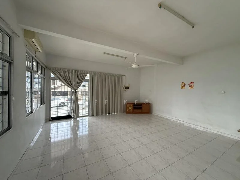 Living features: white painted walls, white tiled flooring, exposed ceiling with beams, 5-blade ceiling fan, large windows with grilles, curtains, wall-mounted cabinet, natural light from windows; style: minimalist.