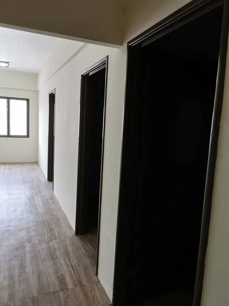 Room features: light wood laminate flooring, white painted walls, black door frames, window with view to outside, multiple doorways.