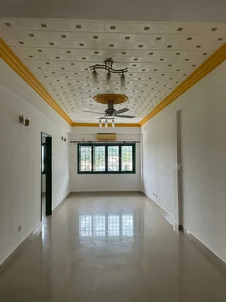Room features: white painted walls, cream ceiling with decorative pattern, gold crown moulding, polished ceramic tile flooring, 5-blade ceiling fan with light, two wall sconces, large windows with black frames, window treatments not visible; style: modern; view: garden.