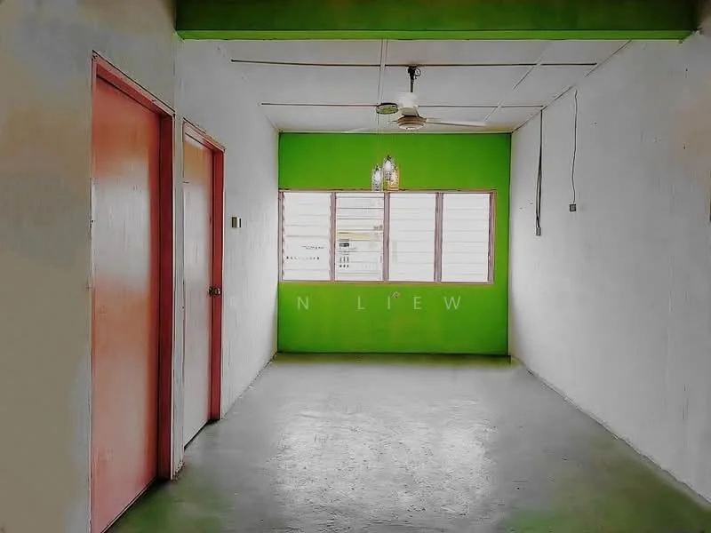 Room features: green accent wall, white painted walls, concrete flooring, ceiling fan, window with horizontal slats, two red doors, light fixture with multiple bulbs; style: minimalist.