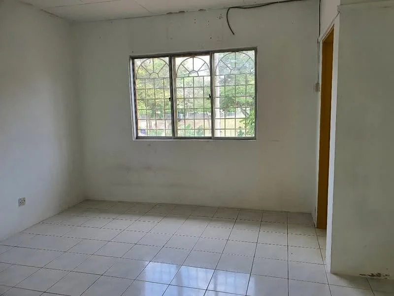 Room features: white painted walls, ceramic tile flooring, window with grid pattern, natural light from window, no visible furniture, plain ceiling, electrical outlet on wall, minimal decor; view: garden.