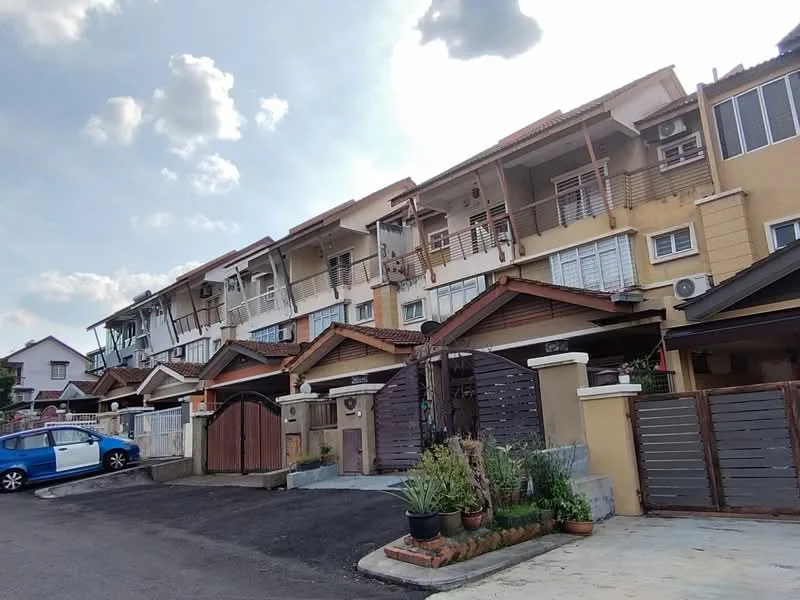 Exterior type: linked terrace house; features: two-storey linked terrace houses, cream painted facade, wooden accents on balconies, sliding glass doors, front porch with potted plants, driveway with interlocking pavers, visible air conditioning units, manicured landscaping, gated entry, street parking available; style: modern.