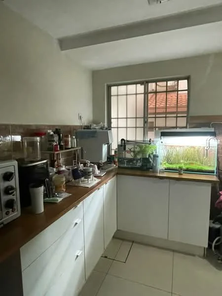 Kitchen features: white cabinetry, wood countertop, stainless-steel sink, chrome faucet, tile backsplash, ceramic tile flooring, window with grid pattern, kitchen appliances including toaster and coffee machine, fish tank, various kitchen utensils and containers; style: modern.