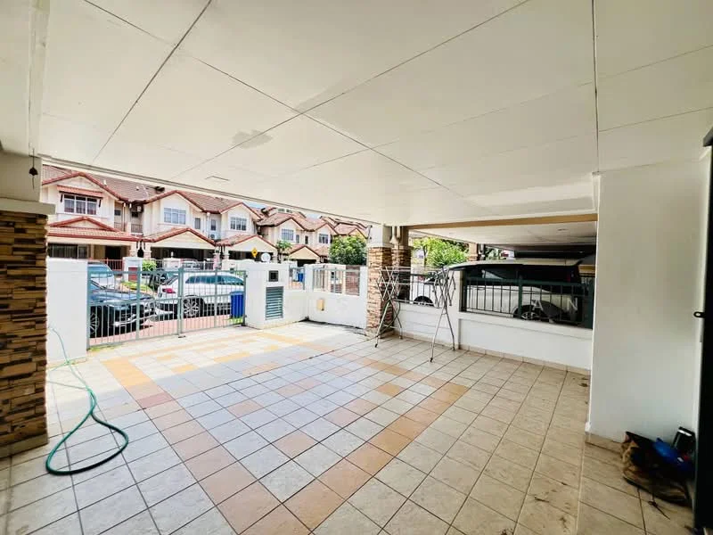 Exterior type: linked terrace house; features: tiled flooring with a mix of beige and brown tiles, white painted walls, covered car porch, manicured lawn visible in the background, fenced perimeter, sliding glass door, outdoor hose, exposed ceiling, interlocking pavers, visible neighboring houses; style: modern.