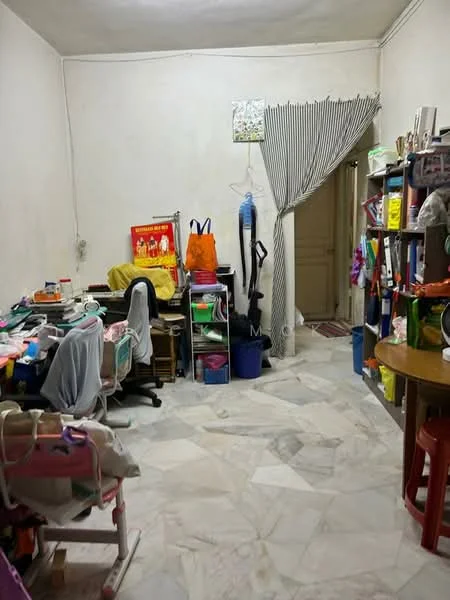 Room features: white painted walls, marble flooring, curtains, wooden table, plastic chairs, bookshelves, storage bins, office supplies, child's high chair, doorway leading to another room.