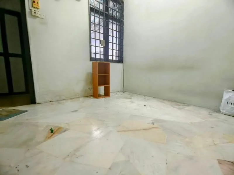 Room features: white painted walls, marble flooring, small wooden shelf, window with metal grille, clean and empty space.