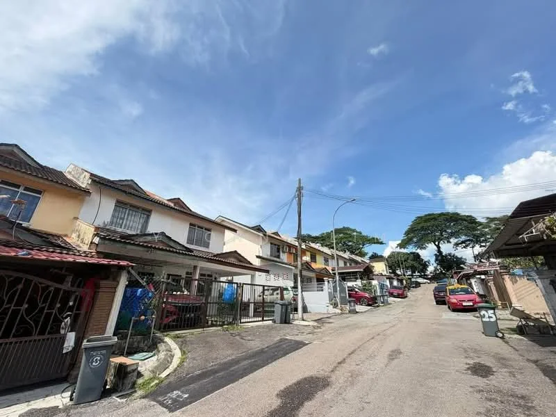 Exterior type: linked terrace house; features: two-storey linked terrace houses, red brick facade, gated entrance, driveway with interlocking pavers, manicured lawn, street view with parked cars, surrounded by mature trees, clear blue sky; style: modern.