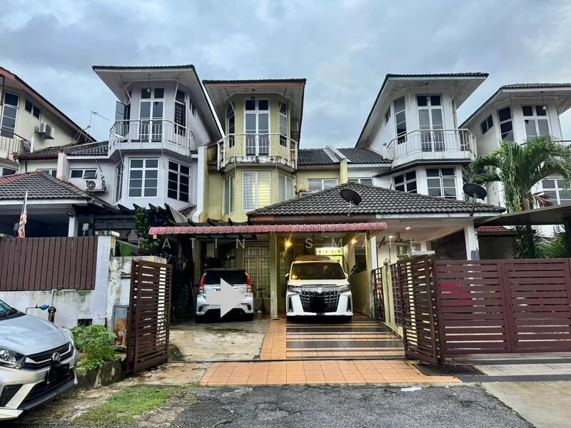 Exterior type: linked terrace house; features: two-storey building, white painted facade, red tiled roof, balconies with railings, driveway with interlocking pavers, manicured lawn, car porch with awning, visible parking spaces, surrounded by greenery, gated entry; style: modern.