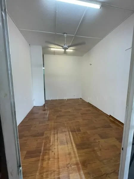 Room features: white painted walls, wooden flooring, ceiling fan, fluorescent ceiling lights.