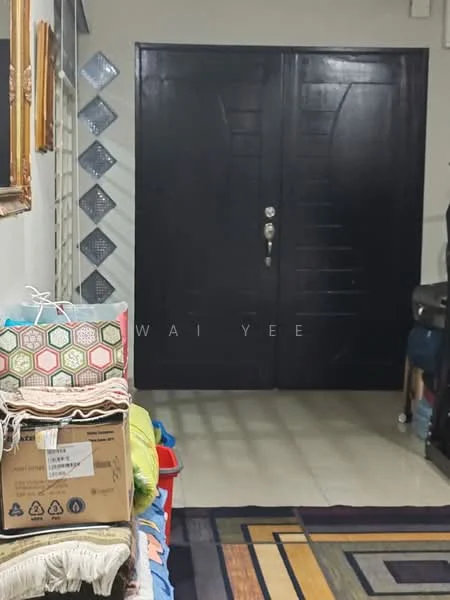 Room features: double wooden doors with vertical paneling, cream tiled flooring, decorative wall mirror, stack of boxes, colorful patterned cushions, textured wall, wall-mounted light fixture, area rug with geometric pattern; style: modern.
