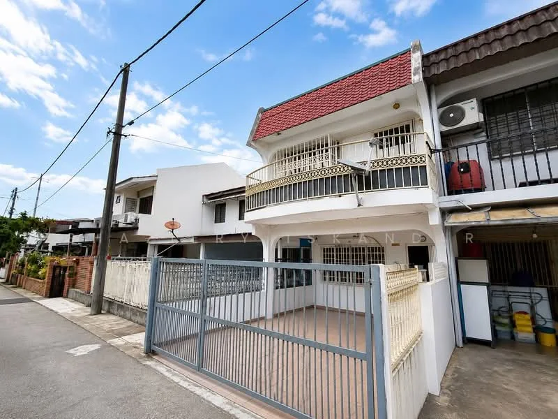Exterior type: linked terrace house; features: red tiled roof, white painted facade, balcony with railing, ground floor parking area, fenced front yard, air conditioning unit visible, two-storey structure, manicured front garden, street view with power lines, clear blue sky; style: modern.