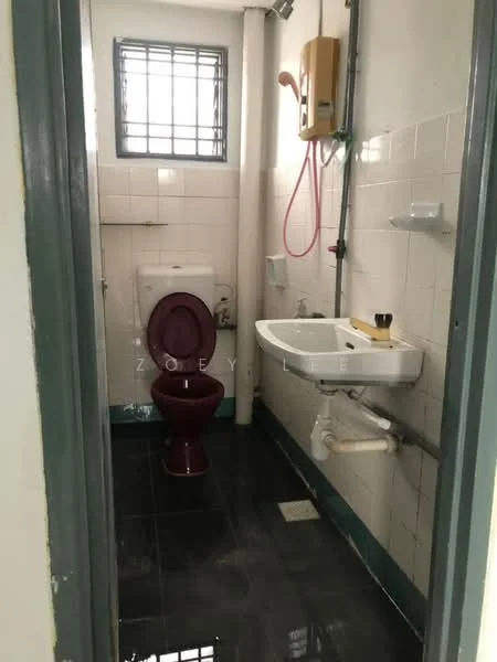 Bathroom features: white tiled walls, black tiled flooring, toilet with maroon seat, sink with wooden countertop, shower with wall-mounted water heater, mirror above sink, window with metal grille, wall-mounted soap holder.