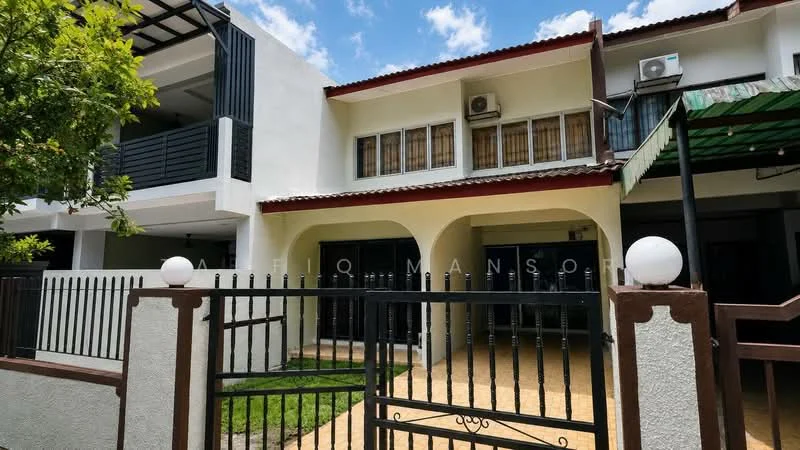 Exterior type: linked terrace house; features: white painted facade, red tiled roof, black wrought iron gate, paved driveway, manicured lawn, balcony on upper floor, air conditioning units visible, covered porch area, outdoor awning, two-storey structure; style: modern.