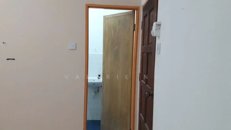 Room features: light beige painted walls, wooden door, white tiled flooring, visible bathroom sink, blue flooring in bathroom, door frame with wood finish.