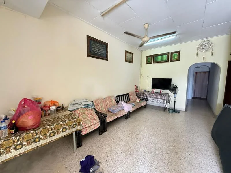 Living features: cream painted walls, exposed ceiling with panels, ceiling fan, tile flooring, sofa seating, decorative wall art, TV console, arched doorway, table with floral tablecloth, various personal items on furniture.